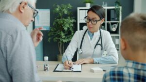 Doctor consults with elderly man and child.