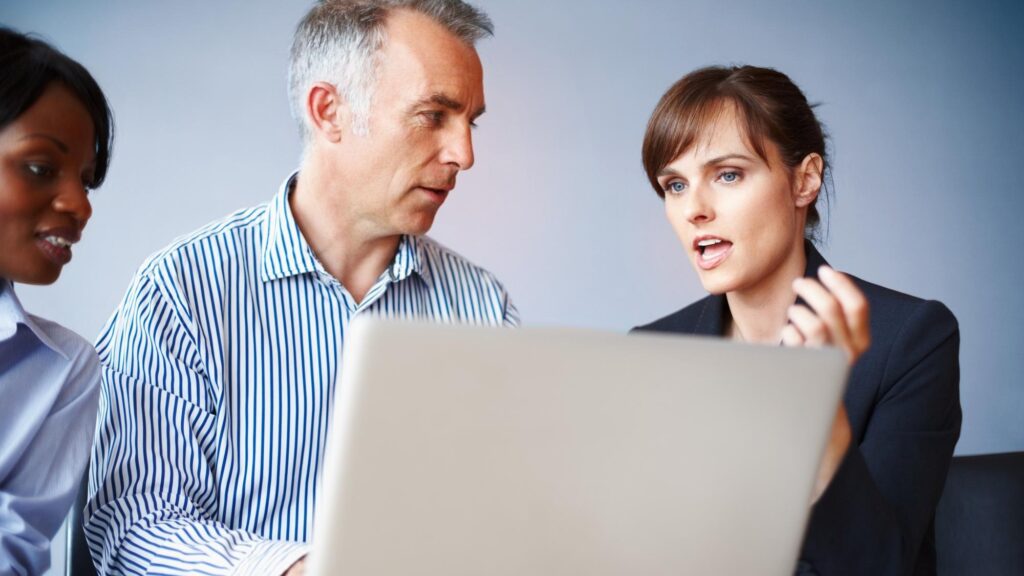 Business people teamwork and laptop with brainstorming ideas and planning with collaboration company website and cooperation Group meeting and man with women office and computer with support