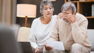 Stress finance and senior couple planning retirement mortgage anxiety and sad about pension paperwork Depression audit and elderly man and woman with a financial crisis and insurance mistake