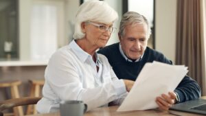 Retirement life insurance paperwork and old couple with policy and planning with security finance