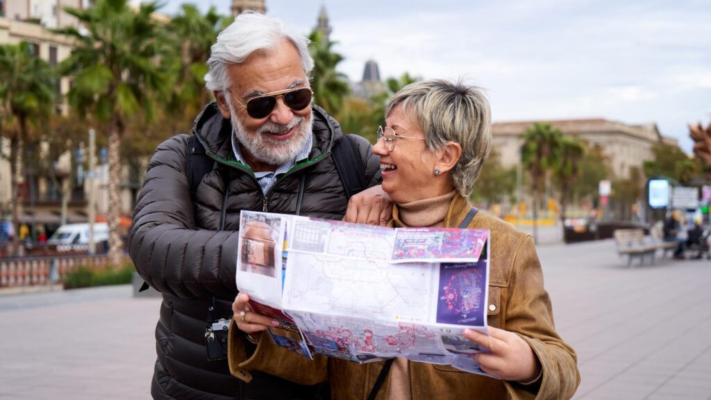 Happy senior couple doing tourism guiding by a paper map in the city