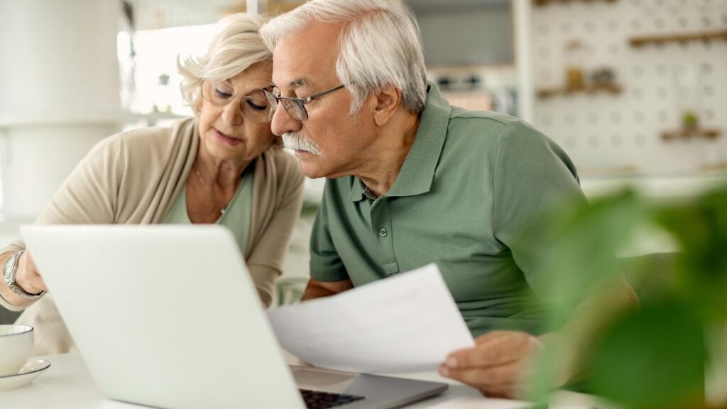 Senior couple analyzing their savings while going through home finances