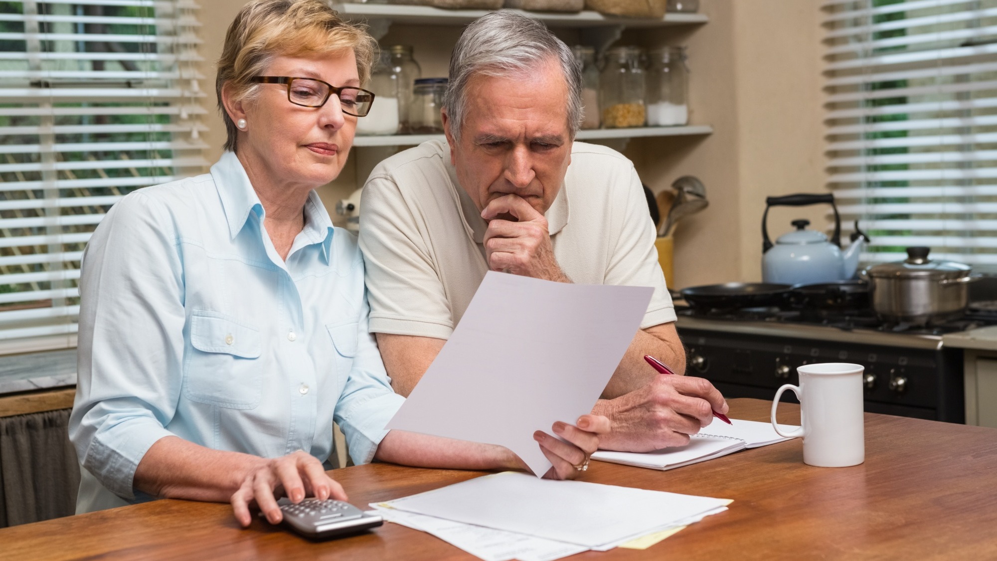 Senior couple working out their bills Senior couple working out their bills