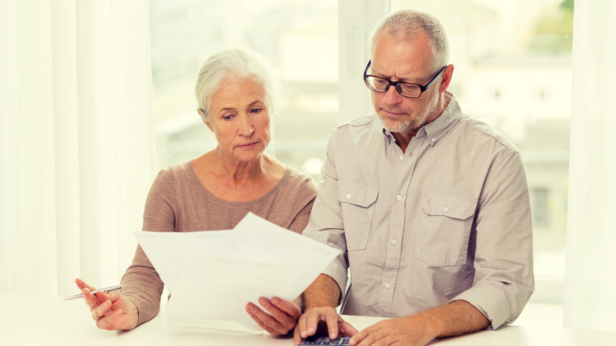 family, business, savings, age and people concept - senior couple with papers and calculator at home family, business, savings, age and people concept - senior couple with papers and calculator at home