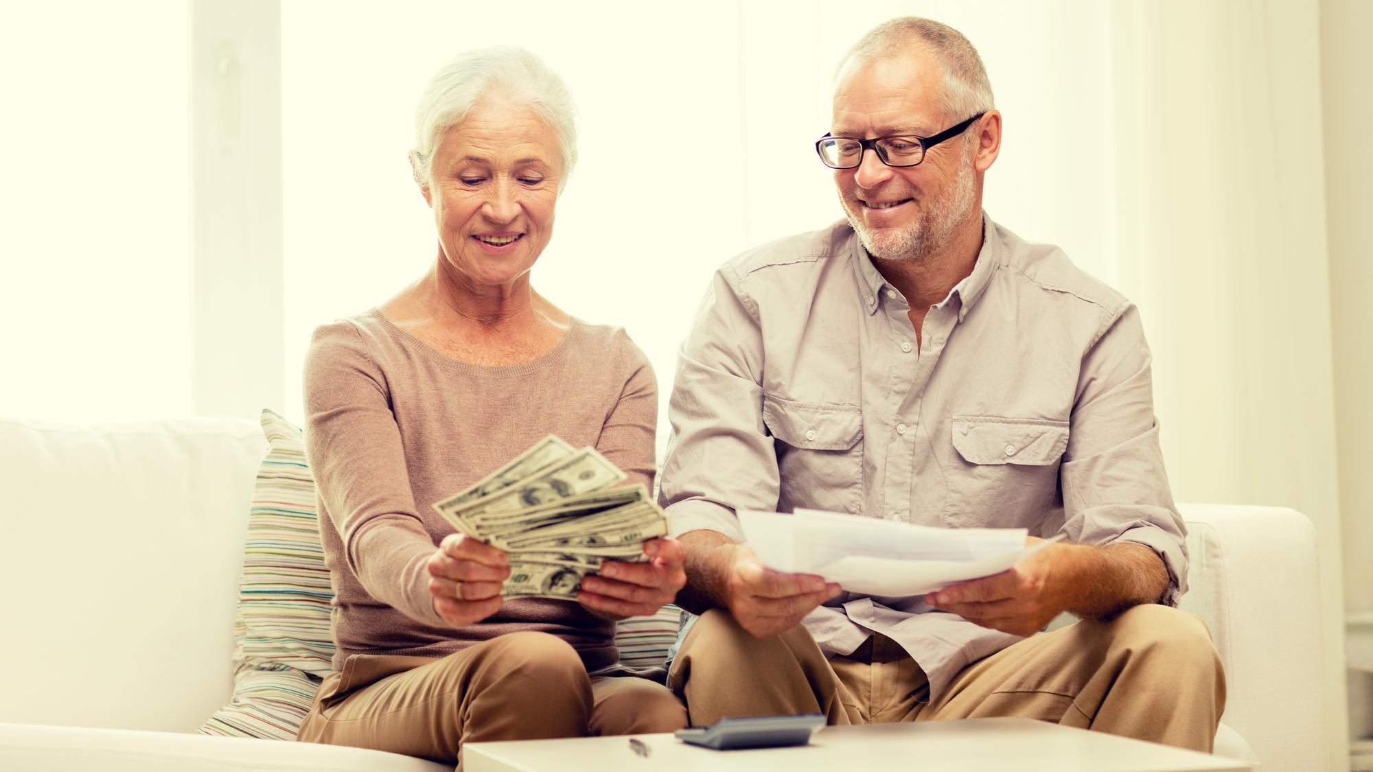 family, business, savings, age and people concept – smiling senior couple with papers, money and calculator at home family, business, savings, age and people concept – smiling senior couple with papers, money and calculator at home