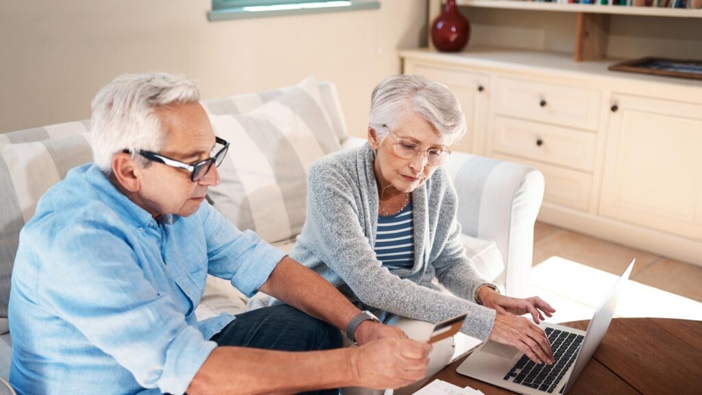 Old couple credit card or password on laptop for mortgage payment with elderly husband or wife Banking household bills or people with retirement savings fund insurance paperwork or investing plan