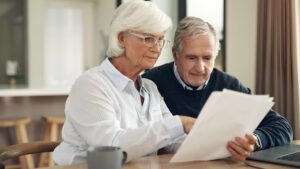 Retirement life insurance paperwork and old couple with policy and planning with security finance