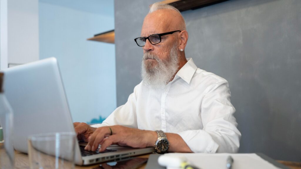 Medium shot senior man typing on keyboard