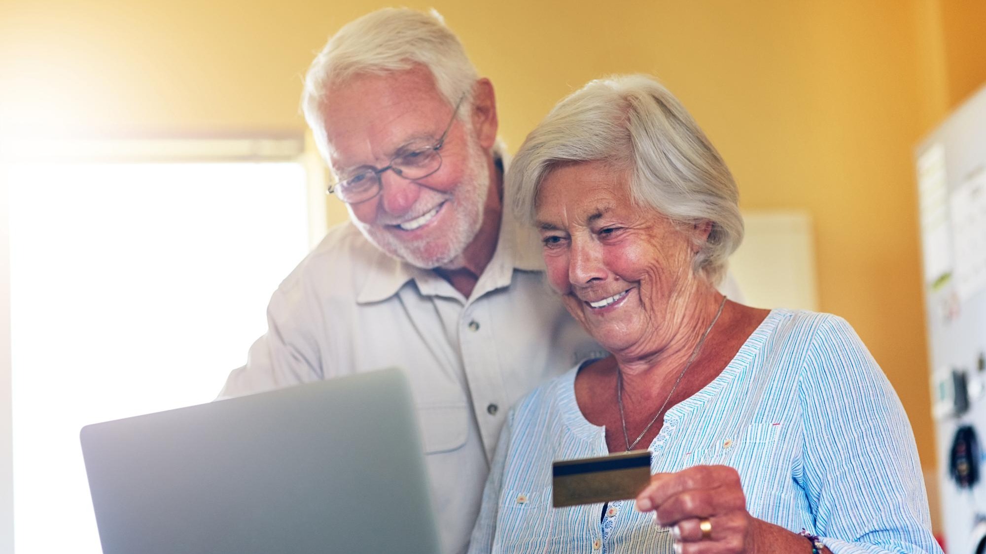 Senior couple credit card and laptop for ecommerce online shopping or subscription in retirement home Excited pensioners cashless and banking at digital store for payment of order or purchase