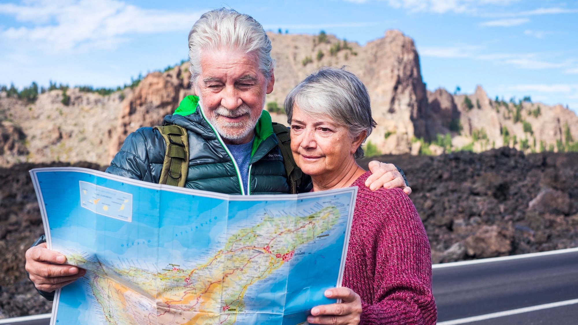 beautiful caucasian aged senior couple man and woman people traveling using old style paper map at the mountain - enjoy the lifestyle and retired life together with a backpack and needs of adventure a beautiful caucasian aged senior couple man and woman people traveling using old style paper map at the mountain - enjoy the lifestyle and retired life together with a backpack and needs of adventure a