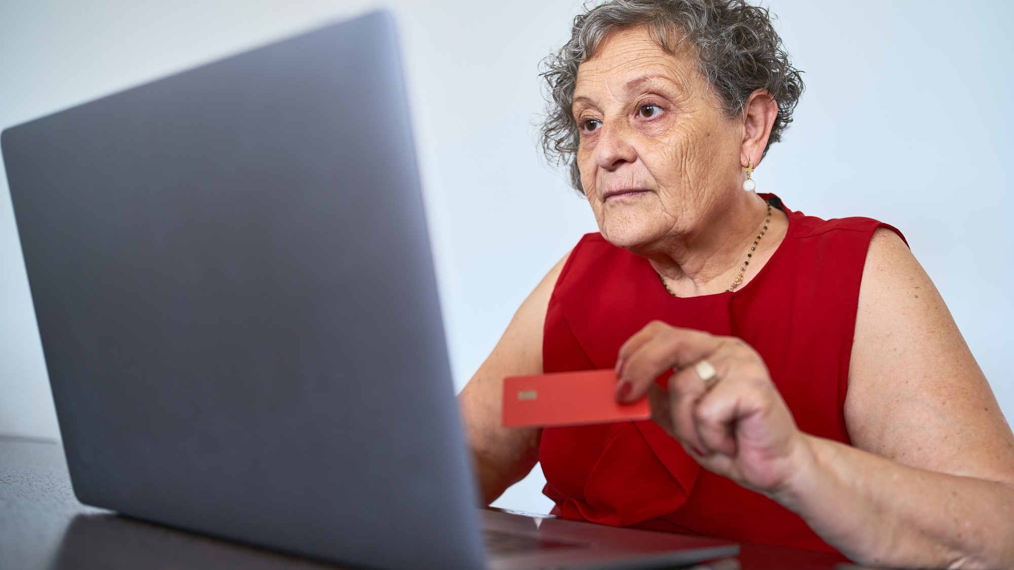 Portrait of senior woman using credit card to buy online Portrait of senior woman using credit card to buy online