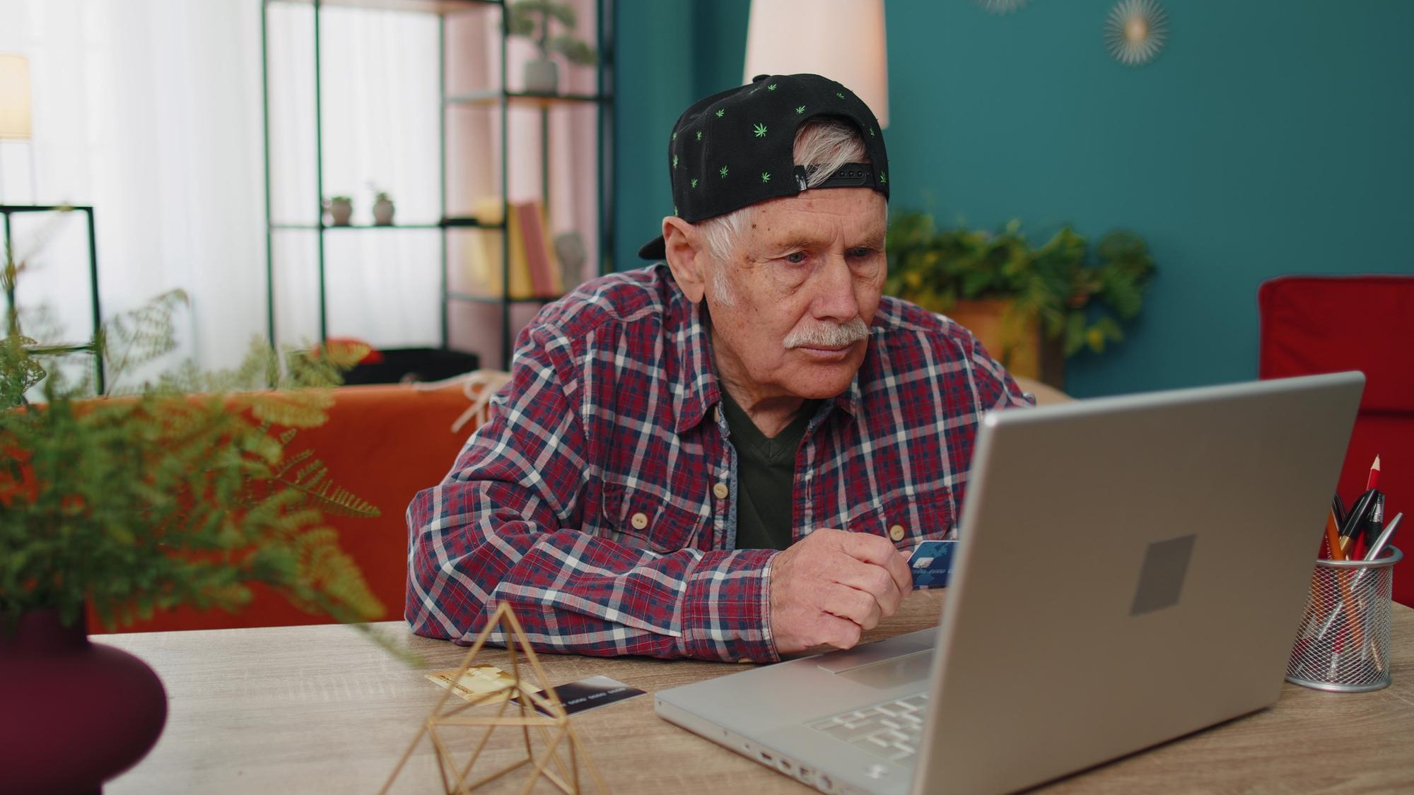 Senior grandfather man typing credit cards information on laptop making internet online shopping Senior grandfather man typing credit cards information on laptop making internet online shopping